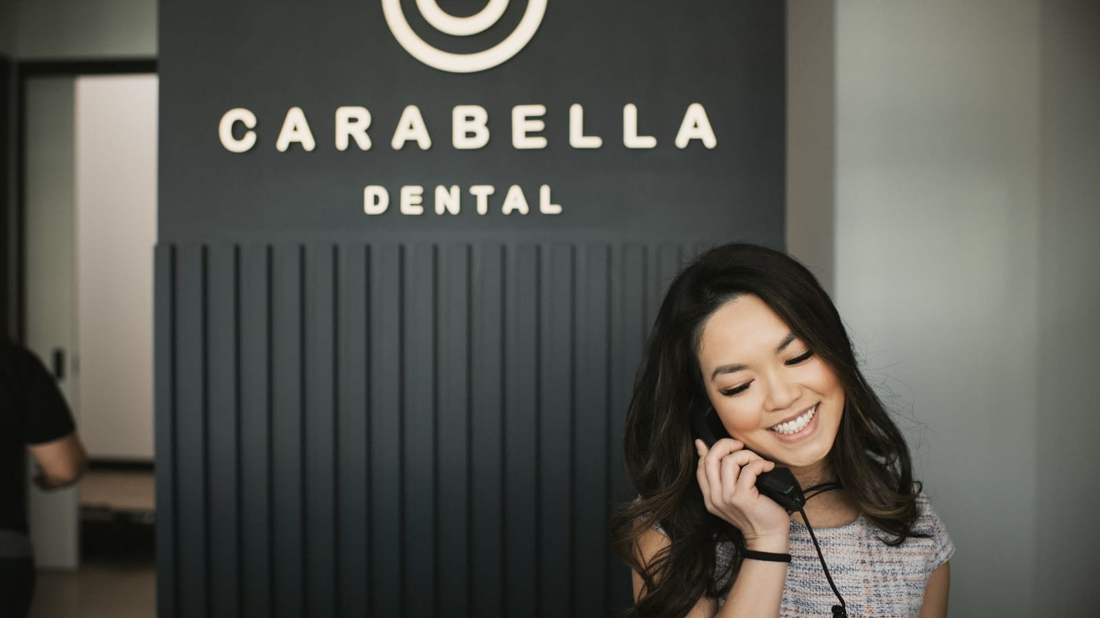 Dr Bella Talking to her client  at dental office in alexandria , Va - Carabella dental